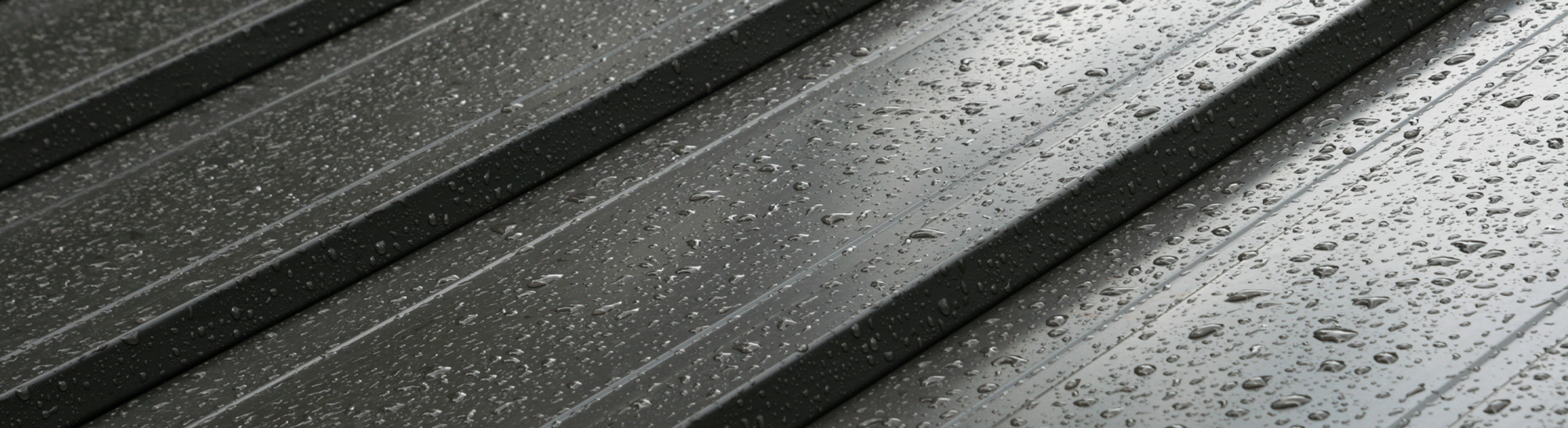 Close up of metal roof panels covered in rain